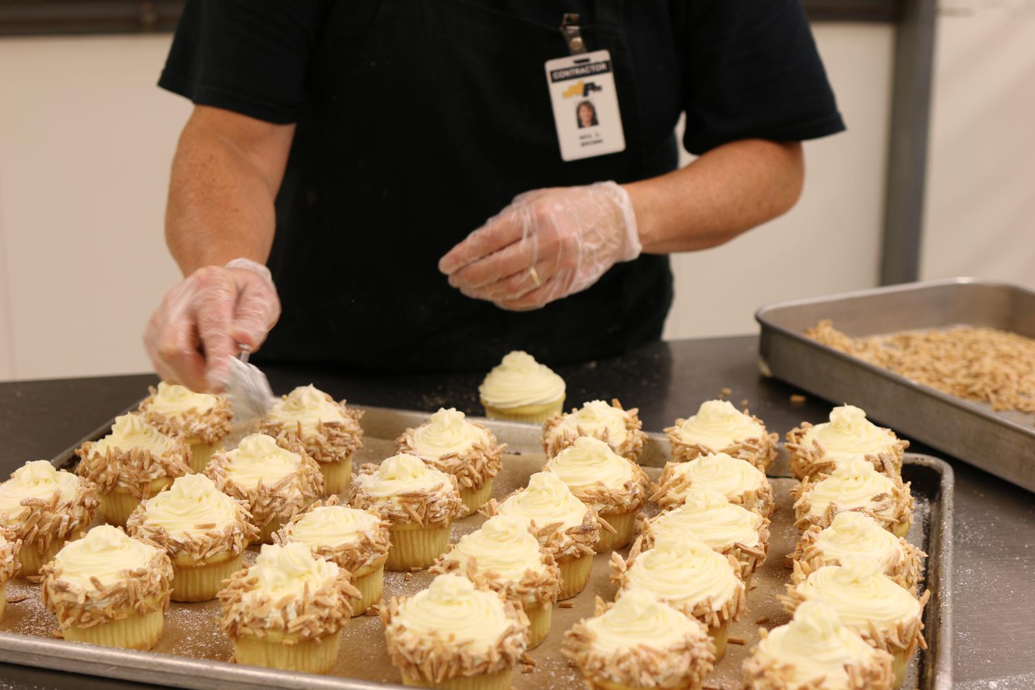 The NASH cafeteria puts the finishing touches on cupcakes for Cohen to be sold at Homecoming.