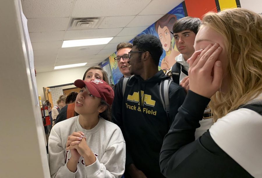 (L-R) Ava DiMartino, Emma Sula, Dylan Noker, Henry Mokube, Josh Truesdell, and Sarah Johns anxiously scan the spring musical callback list posted on September 27th.