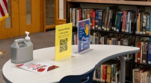 Social distancing signs and bottles of hand sanitizer throughout the library remind students just how different this school year is.