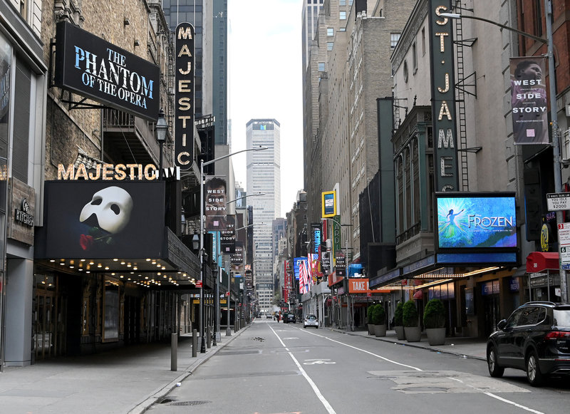 Nothing but dimmed lights and dark marquees are left on the once-bustling streets of Broadway.