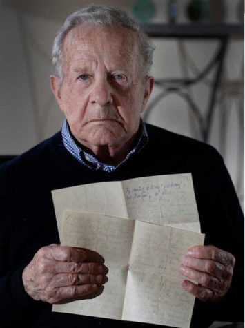 Survivor, Frank Grunwald, holds up the goodbye letters that his mother wrote to his father before she and her eldest son were sent to the Nazi gas chambers.