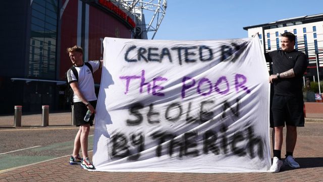 Supporters protest the proposed European Super League outside of Old Trafford