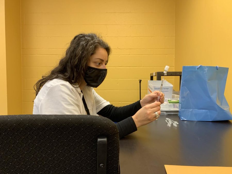 A pharmacist from Giant Eagle fills up a vaccine with the Pfizer-BioNTech solution.