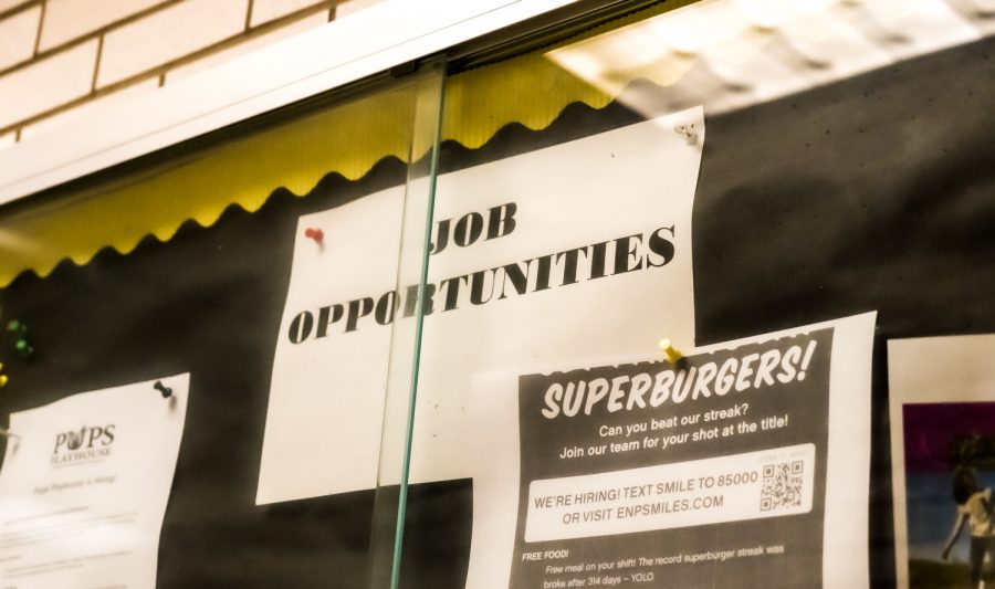 Job postings hung up in the NASH Cafeteria trophy display.