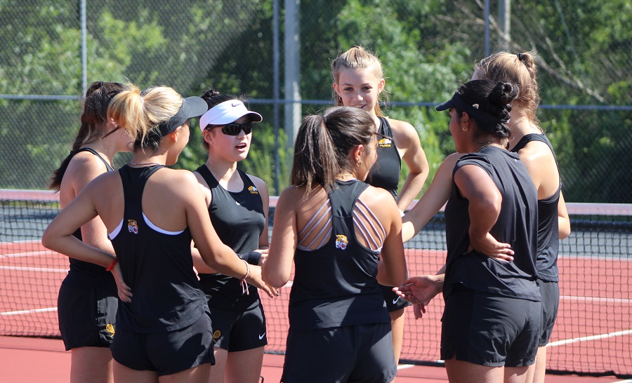 The members of the Girls Tennis team have one last discussion before a match.