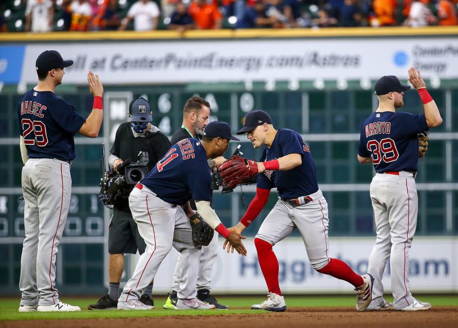 Oct 16, 2021; Houston, Texas, USA; Boston Red Sox center fielder Enrique Hernandez (5) and third baseman Rafael Devers (11) celebrate after the Red Sox defeated the Houston Astros in game two of the 2021 ALCS at Minute Maid Park. Mandatory Credit: Troy Taormina-USA TODAY Sports