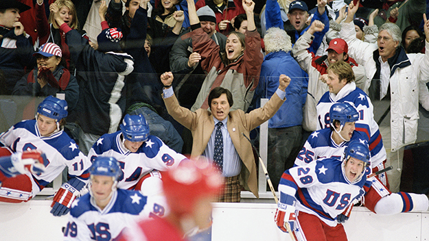 Coach Herb Brooks (played by Kurt Russel) celebrates on Team USAs bench in the movie Miracle.