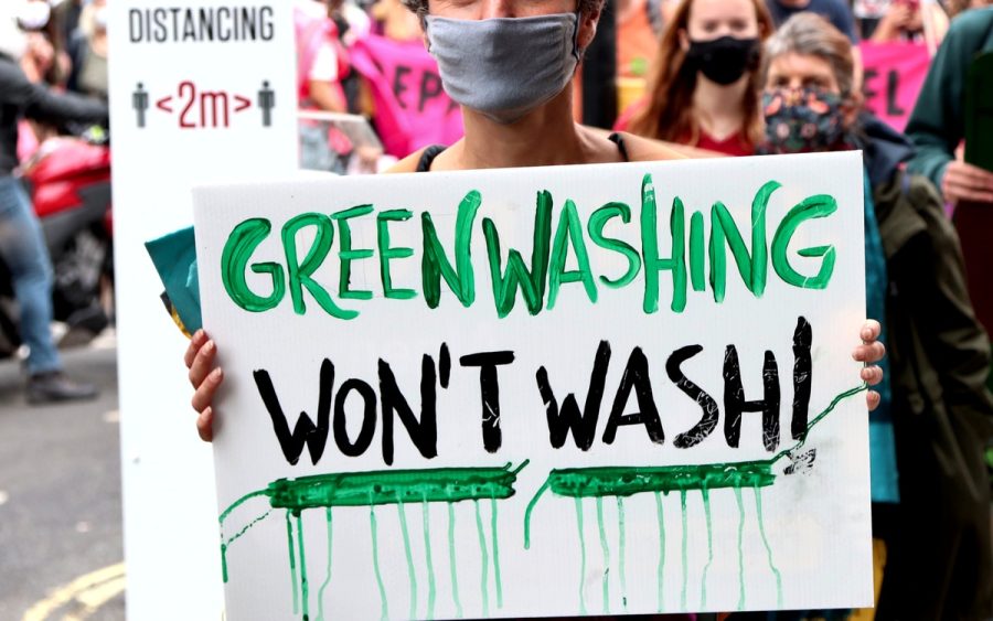 Anti-greenwashing activists protest against huge corporations like Johnson & Johnson, IKEA, and ExxonMobil.