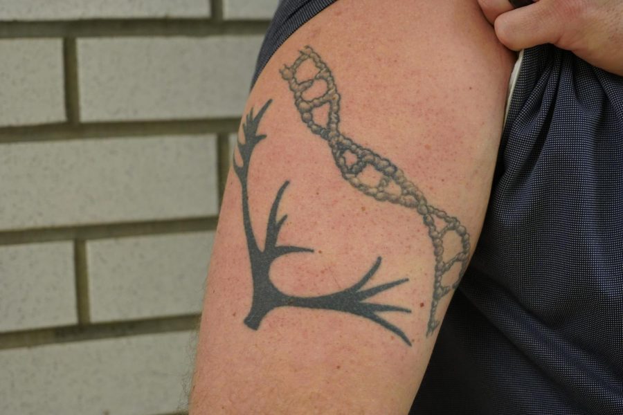 AP Biology teacher Mr. Allen proudly displays one of his tattoos.