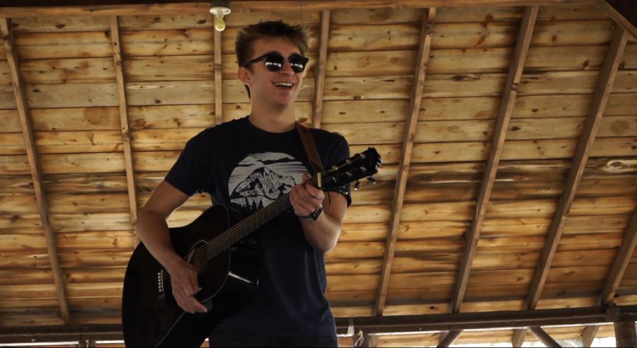 NASH senior Hunter Badamo plays guitar in his music video for Turning Upside Down. His new song, Life Gets Sick of Us, releases today. 
