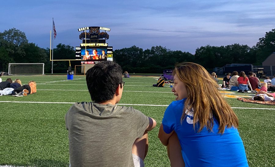 Owen Jin and Victoria Ren enjoy a night of movie-watching on the field at Newman Stadium.