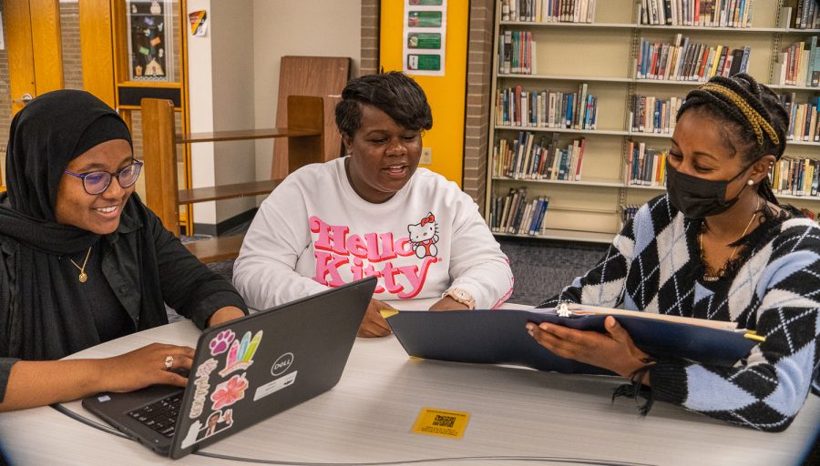 Lamees Subeir (left), CharTise Cooks (center), and Elise Britton (right), founders of the Black Student Union, meet in the NASH Library to arrange plans for the year.
