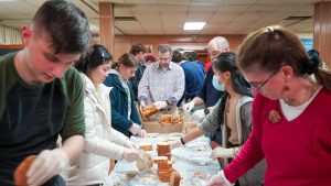 Interact members Bruno Martin, Ashley Shim, and Summer Ji joined volunteers from around the area at St. Marys Holy Assumption Orthodox Church last Wednesday evening to prepare meals for families in need.