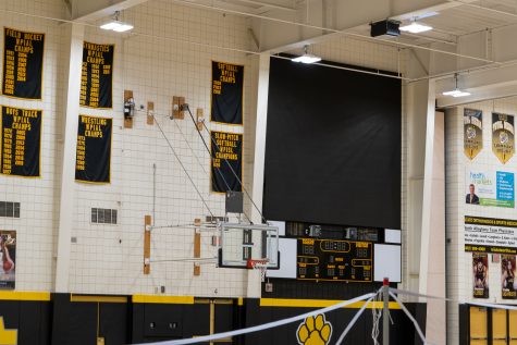 The videoboards installed in the NASH gym loom large in comparison to displays in other local high school gyms.