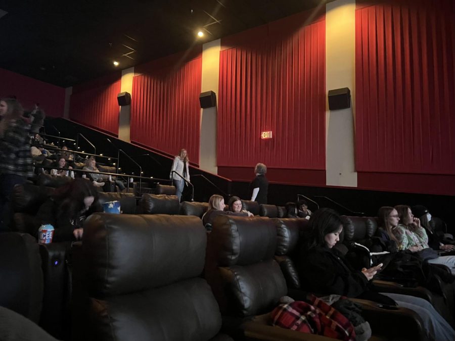 The theater fills as teens and teachers grab their popcorn and settle into their seats.
