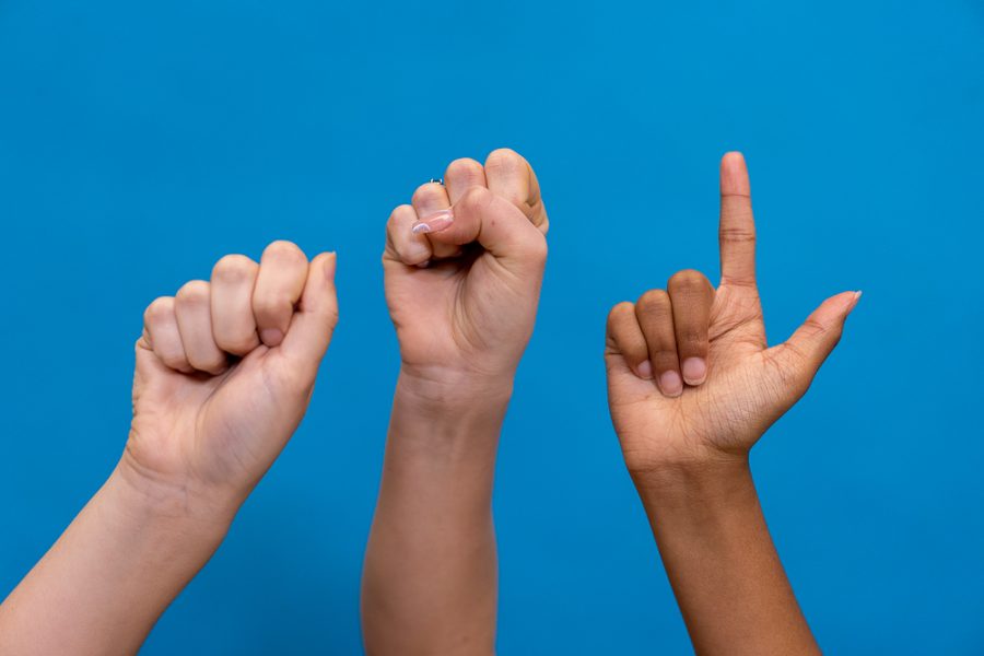 The hands above spell ASL in American Sign Language.