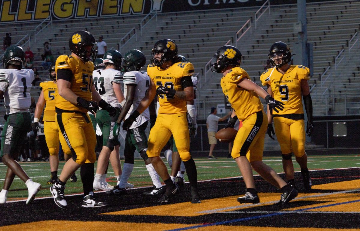 Tigers after a touchdown in a week 0 matchup against Allderdice