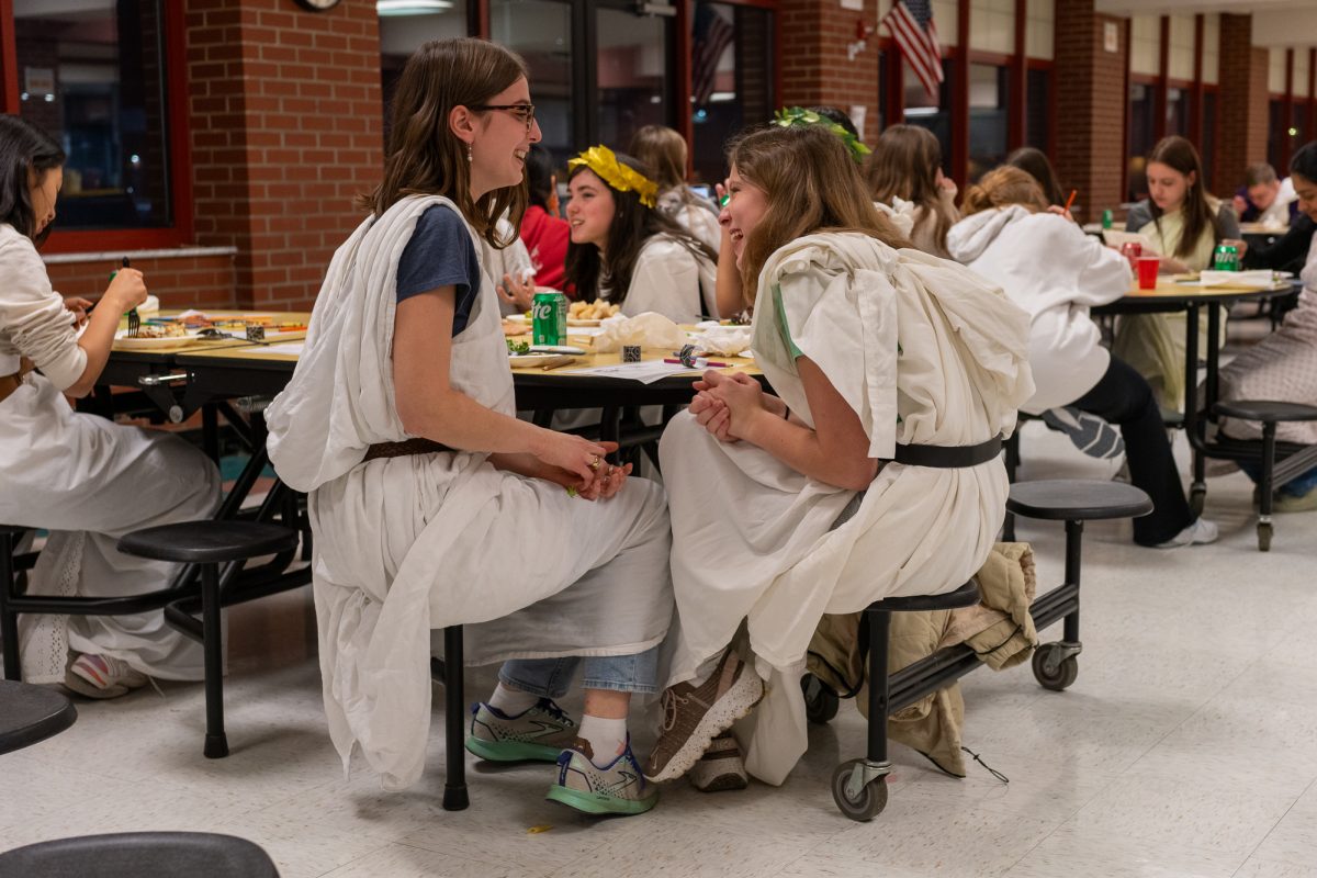 JCL members Amelia Oddo and Daisy Lucas (l-r) gather in the NAI cafeteria on the evening of December 13th.