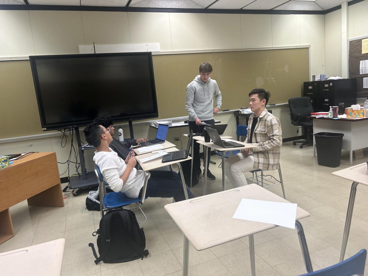 Seniors Tharun Sunthar (Back Left), Zohaib Rahman (Front Left), Peter Ricci (Back Right), and Gavin Hou (Front Right) compete in a heated round of Public Forum debate.