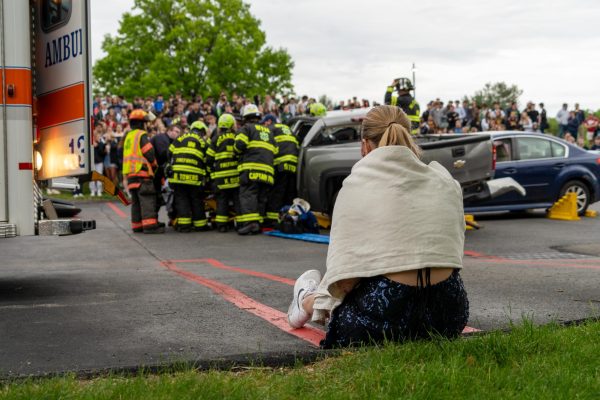 NASH senior Elizabeth Vales, the driver of the truck that was hit, watches as medics and firefighters attempt to save lives.
