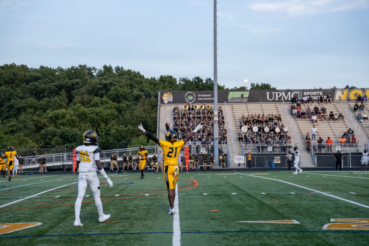 Junior cornerback Korry Pitts raises his arms as victory draws near. Pitts would go on to secure a game-clinching interception versus St. Frances Academy Regional last Friday.