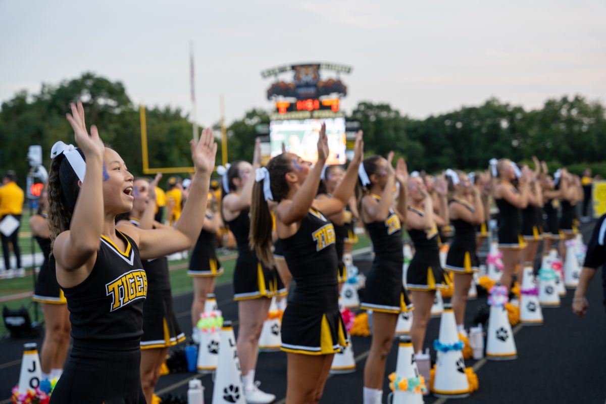 The Cheerleading Team performs at the football home opener at Newman Stadium on August 23.