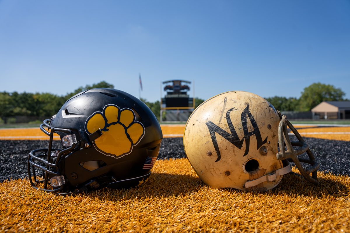 Two Tiger football helmets, one from the current season and the other from the 1960s.