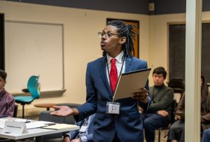 NASH senior Charles Potter delivers the opening statement for a murder mock trial, the capstone project of the Honors Argument course.