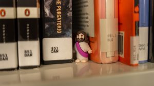 A mini-Jesus peeks through the shelves in the NASH Library.