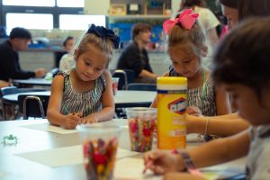 Preschoolers enjoy coloring with friends during their sixth period class at NASH.