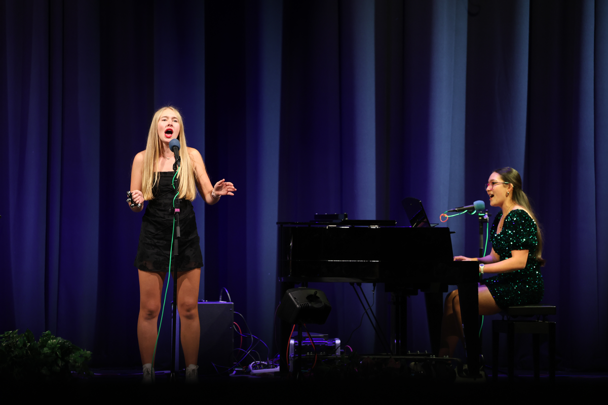 NASH seniors Kirsten Karlovits and Isabella Lin sing "Santa Can't You Hear Me" at Monday evening's NASH cabaret. (photo: Bob Tozier)