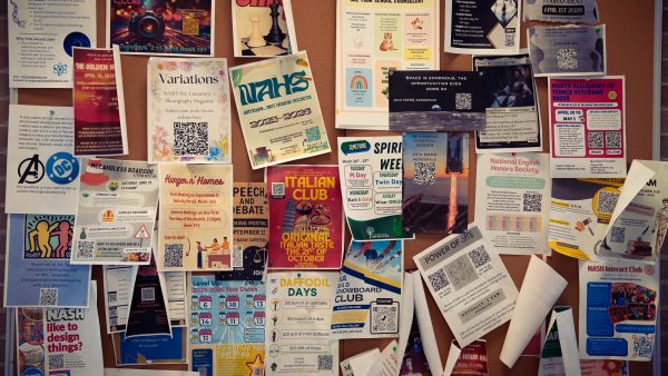An assortment of club advertisements on a second-floor bulletin board at NASH.